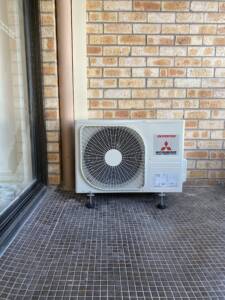 Mitsubishi split ourdoor unit installed on a balcony at Cremorne.