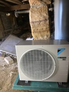 Daikin split system outdoor unit installed under the house at Mosman
