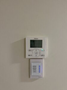 Wall mounted ac control for a ducted system and a zone control