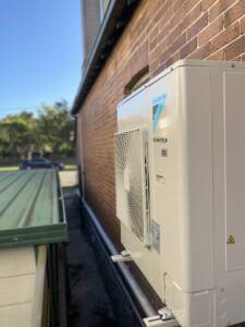 Ducted system outdoor AC attached to the wall at Neutral Bay