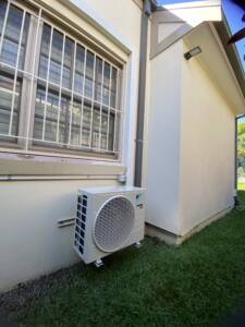 Outdoor AC unit installed on wall brackets at Neutral Bay