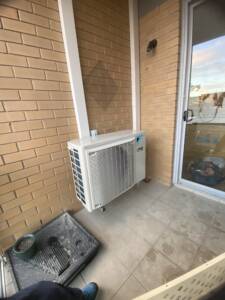 Ducted system outdoor unit on a balcony