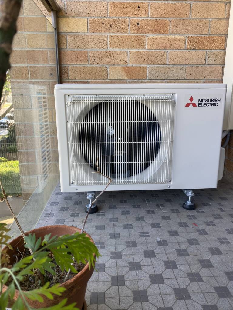Mitsubishi outdoor ac unit installed on a balcony